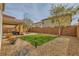 Backyard with a lawn, desert landscaping and a covered patio, surrounded by a block wall at 6655 Little Owl Pl, North Las Vegas, NV 89084