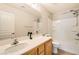 A bright bathroom with a modern vanity, full mirror, and a pristine white shower-tub combination at 6655 Little Owl Pl, North Las Vegas, NV 89084