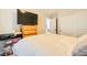 A cozy bedroom featuring a bed, TV on a wooden dresser, and a sliding closet with overhead lighting at 6655 Little Owl Pl, North Las Vegas, NV 89084