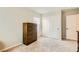 Bright bedroom featuring neutral carpet, blinds, a dresser, and large sliding closet doors for ample storage at 6655 Little Owl Pl, North Las Vegas, NV 89084