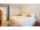 Well-lit bedroom features a plush bed and sliding closet doors for ample storage and a minimalist aesthetic at 6655 Little Owl Pl, North Las Vegas, NV 89084