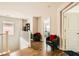 Bright hallway features wood floors, seating, and view into an adjacent bedroom at 6655 Little Owl Pl, North Las Vegas, NV 89084
