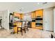 Bright kitchen featuring stainless steel appliances, wooden cabinets, and a center island with barstool seating at 6655 Little Owl Pl, North Las Vegas, NV 89084