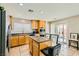 Modern kitchen featuring stainless steel appliances, an island with bar seating and access to backyard at 6655 Little Owl Pl, North Las Vegas, NV 89084