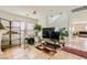 Spacious living room with tile floors, neutral walls, and a staircase leading to the second floor at 6655 Little Owl Pl, North Las Vegas, NV 89084