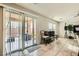Bright living room featuring tile floors, sliding glass door to patio and natural light at 6655 Little Owl Pl, North Las Vegas, NV 89084