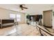 Bright living room with tile floors, neutral walls, and a large window at 6655 Little Owl Pl, North Las Vegas, NV 89084