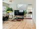 Open-concept living room featuring tile floors, neutral walls, and a staircase leading to the second floor at 6655 Little Owl Pl, North Las Vegas, NV 89084