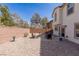 Private backyard with desert landscaping, brick wall, and outdoor seating area at 6924 Ghost Ranch Ave, Las Vegas, NV 89179