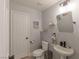 Cozy bathroom with pedestal sink, seashell decor, and convenient toilet placement at 6924 Ghost Ranch Ave, Las Vegas, NV 89179