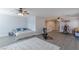 Spacious bonus room with two ceiling fans, exercise equipment, and ample natural light at 6924 Ghost Ranch Ave, Las Vegas, NV 89179
