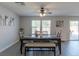Charming dining room with a table for six and sliding glass doors to the outdoor patio at 6924 Ghost Ranch Ave, Las Vegas, NV 89179