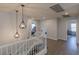Upstairs hallway with modern lighting fixtures and neutral paint color and wood floors at 6924 Ghost Ranch Ave, Las Vegas, NV 89179