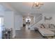 Spacious living room with an open staircase, stylish decor, and ample natural light at 6924 Ghost Ranch Ave, Las Vegas, NV 89179