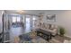 Bright living room featuring hardwood floors, a sectional sofa, and stylish decor at 6924 Ghost Ranch Ave, Las Vegas, NV 89179