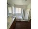 Spacious bathroom with a large soaking tub and glass-enclosed shower at 731 Emerald Idol Pl, Henderson, NV 89011