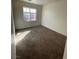 Simple yet cozy bedroom with carpet flooring and a bright window at 731 Emerald Idol Pl, Henderson, NV 89011