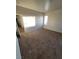 An airy bedroom featuring neutral-toned walls, carpet flooring, and a window that offers natural light at 731 Emerald Idol Pl, Henderson, NV 89011