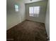 Bright bedroom with neutral walls, carpet flooring, and large windows providing natural light at 731 Emerald Idol Pl, Henderson, NV 89011