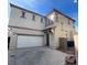 Charming two-story home featuring a neutral stucco facade, a two-car garage, and a well-maintained front yard at 731 Emerald Idol Pl, Henderson, NV 89011