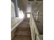 Upstairs carpeted hallway with railing and natural light from a window at 731 Emerald Idol Pl, Henderson, NV 89011