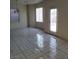 A living room featuring light walls, tile flooring and a sliding glass door that leads outside at 731 Emerald Idol Pl, Henderson, NV 89011