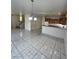 Spacious living room with tile flooring, modern lighting, and an open kitchen area at 731 Emerald Idol Pl, Henderson, NV 89011