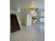 Inviting living room featuring tiled floors, ceiling fan, and staircase leading upstairs at 731 Emerald Idol Pl, Henderson, NV 89011