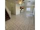 Open-concept living area with tile floors, staircase, and views into the kitchen at 731 Emerald Idol Pl, Henderson, NV 89011