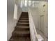 Carpeted staircase with white railing leads to the upper level of the home at 731 Emerald Idol Pl, Henderson, NV 89011