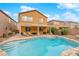 Private backyard oasis featuring a sparkling pool, covered patio, and lush landscaping at 765 Crimson Peak Pl, Henderson, NV 89011