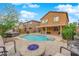 Backyard with pool, spa, desert landscaping, fire pit and lounge chairs for relaxation and entertaining at 765 Crimson Peak Pl, Henderson, NV 89011