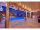 Charming outdoor space with a pool, hot tub, built-in grill, and covered patio at 765 Crimson Peak Pl, Henderson, NV 89011