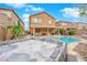 Backyard with pool and spa, perfect for relaxation, with lush landscaping and lounge chairs at 765 Crimson Peak Pl, Henderson, NV 89011