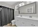 Bright bathroom with double sink vanity, large mirror, and shower with curtain at 765 Crimson Peak Pl, Henderson, NV 89011