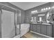 Bathroom featuring double sinks, a soaking tub, and separate shower with glass door at 765 Crimson Peak Pl, Henderson, NV 89011