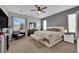 Spacious bedroom featuring plush carpet, a ceiling fan, and lots of natural light at 765 Crimson Peak Pl, Henderson, NV 89011