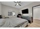 Comfortable bedroom with modern decor featuring a ceiling fan, full mirror, and built-in desk area at 765 Crimson Peak Pl, Henderson, NV 89011