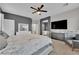 Bright bedroom features contemporary design elements including carpeted floors and a ceiling fan at 765 Crimson Peak Pl, Henderson, NV 89011
