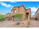 Charming two-story home featuring desert landscaping, an attached garage, and a welcoming entrance at 765 Crimson Peak Pl, Henderson, NV 89011
