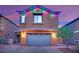 Charming two-story home featuring a brick driveway, and festive holiday lighting at 765 Crimson Peak Pl, Henderson, NV 89011