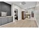 Hallway with wood floors, wood paneling, built-in cabinets with wet bar, and access to the main bedroom at 765 Crimson Peak Pl, Henderson, NV 89011