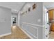 Hallway with decorative wall molding, neutral paint, and view to a living room space at 765 Crimson Peak Pl, Henderson, NV 89011