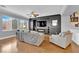 Bright living room boasts hardwood floors, large windows, and a stylish entertainment center at 765 Crimson Peak Pl, Henderson, NV 89011