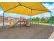 Community playground featuring a colorful play structure, slide, and covered area for shade at 765 Crimson Peak Pl, Henderson, NV 89011