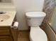 Bathroom featuring tile flooring, toilet and sink with silver hardware and decorative cabinetry at 7732 Blackbird Ave, Las Vegas, NV 89145