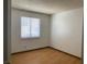 An interior shot of a bedroom featuring wood-look floors and a window with blinds at 7732 Blackbird Ave, Las Vegas, NV 89145