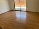 Bedroom featuring wood-look floors and sliding glass doors to a patio area at 7732 Blackbird Ave, Las Vegas, NV 89145