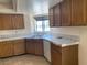 Kitchen featuring wooden cabinets, tile countertops, and stainless steel appliances at 7732 Blackbird Ave, Las Vegas, NV 89145