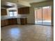 Kitchen with sliding doors to the back, tile counters, and wooden cabinets at 7732 Blackbird Ave, Las Vegas, NV 89145
